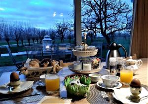 a table with food and eggs on top of it at Logies De Meerkoet in Dudzele