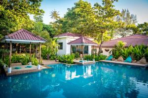 a swimming pool in front of a villa at By The Sea Koh Mak Boutique Guesthouse in Ko Mak