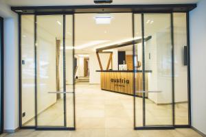 an entrance to a store with sliding glass doors at Austria Aparthotel in Fiss