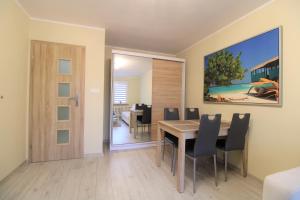 a dining room with a table and chairs at Apartament Gdynia KAZART.PL 3 Centrum in Gdynia