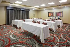 a conference room with white tables and chairs at Holiday Inn Express & Suites Bloomington West by IHG in Bloomington +41 photos