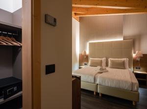 a hotel room with a bed and a desk at X Alp Hotel in Pozza di Fassa