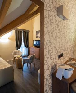 a bedroom with a bed and a desk at X Alp Hotel in Pozza di Fassa