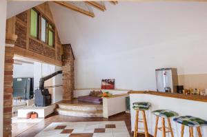 a kitchen with a stove and some stools in a room at Agroturystyka Leśna Dolinka in Narty