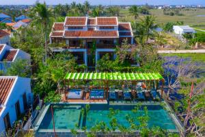 an aerial view of a house with a swimming pool at Hoi An Chic - Green Retreat in Hoi An