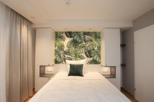 A bed or beds in a room at Wilmas Apartments by Arbio