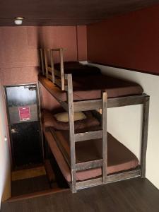 a group of bunk beds in a small room at Stella Resort in Naha