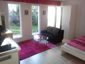 a living room with a couch and a table at Appartementanlage Tecklenburger Altstadt in Tecklenburg