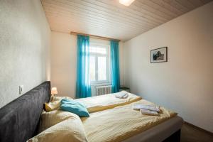 a bedroom with a bed with two towels on it at Alpenblume - Direct lake view in Brienz +20 photos