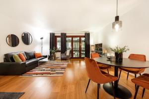 a living room with a table and a couch at Tjuvholmen I, As Home in Oslo
