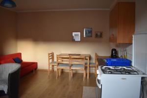 a kitchen and dining room with a table and a stove at Chalupa Iveta in Oščadnica