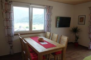 a dining room table and chairs with a window at Appartements Dürnle in Mühldorf