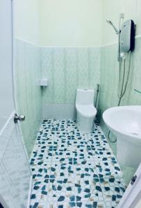 a bathroom with a toilet and a sink at Eden House & Coffee Con Dao in Con Dao