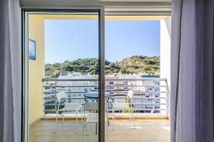 a room with a balcony with a table and chairs at Amazing apartment in Albufeira in Albufeira