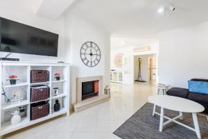a living room with a couch and a fireplace at Amazing apartment in Albufeira in Albufeira
