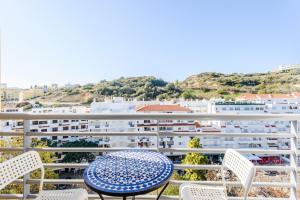 a balcony with a table and chairs and a building at Amazing apartment in Albufeira in Albufeira