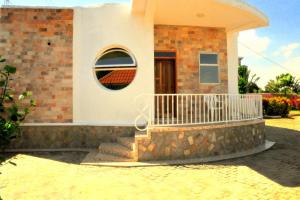 a brick house with a round window and stairs at Victoria Lake View Guesthouse & Safaris in Entebbe
