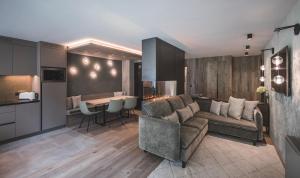 a living room with a couch and a table at Luxegg - Mountain Lodge in Lutago