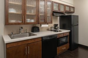 a kitchen with a sink and a refrigerator at Candlewood Suites Vancouver/Camas, an IHG Hotel in Vancouver