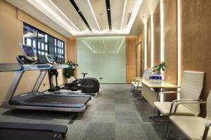 a gym with a treadmill and a table and chairs at Holiday Inn Express Guilin City Center by IHG in Guilin