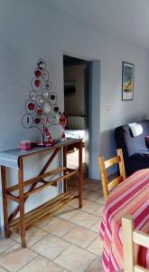 Una habitación con una mesa con un árbol de Navidad. en L'air pur 1 en Roisin
