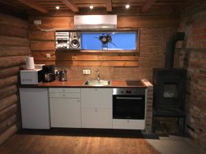 a kitchen with a sink and a stove in a room at Mi Sann Holiday Home in Haanja