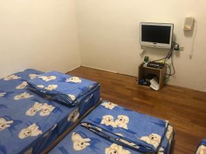 a bedroom with two beds with dalmatians on them at Ji Xiang in Xiaoliuqiu
