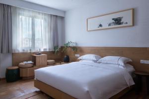 Postel nebo postele na pokoji v ubytování Huanghsan SU House
