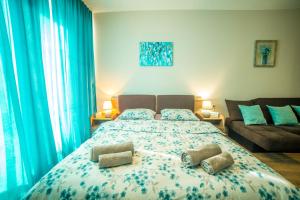 a bedroom with a bed with two pillows on it at BAKURIANI PLAZA A-208 in Bakuriani
