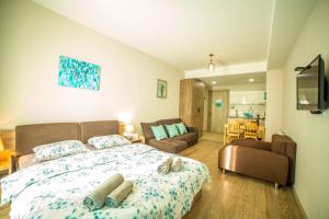a bedroom with a bed and a living room at BAKURIANI PLAZA A-208 in Bakuriani