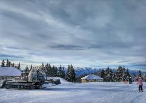 a bulldozer on top of a snow covered slope at Guest Rooms Metaksinovi in Chepelare