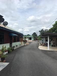 an empty street in a town with a building at OPRO S&S Homestay Pagoh Malay Only in Muar