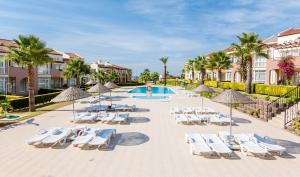 a group of lounge chairs and a swimming pool at a resort at Apollonium Bozbuk in Akbük