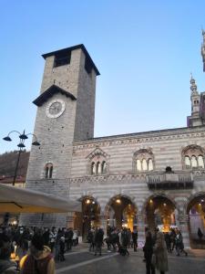 un edificio con una torre de reloj con multitud de personas en Appartamento Aleph, en Como