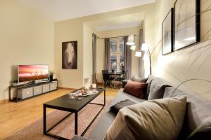 a living room with a couch and a table at Vika II, As Home in Oslo