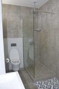 a bathroom with a toilet and a glass shower at 808 St Tropez in Cape Town +10 photos