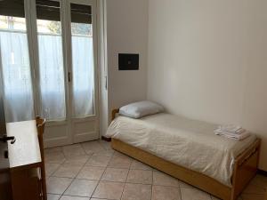 Ένα ή περισσότερα κρεβάτια σε δωμάτιο στο Kibilù - Via Magenta 31 Centro Città con Parcheggio