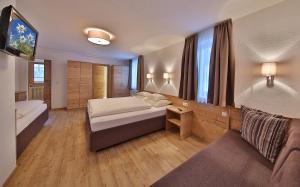 Postel nebo postele na pokoji v ubytování Hotel Garni Fiegl Apart