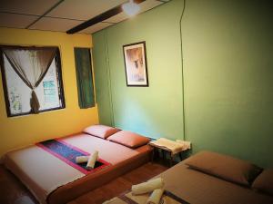 a room with two beds and a window at MoonTree47 in George Town