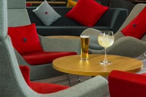 a glass of wine sitting on a wooden table at Holiday Inn Express Newport, an IHG Hotel in Newport