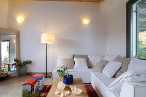 a living room with a white couch and a table at Aegea Blue Cycladic Resort in Zorgos 