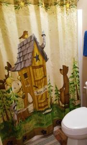 a bathroom with a mural of a house with animals at Bear Cove Inn in Saint Ignace