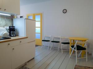 a kitchen with a refrigerator and a table and chairs at Casa Ghioceilor in Vatra Dornei