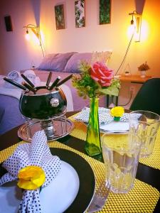 a table with a vase of flowers on top of it at Loft Giese in Navegantes