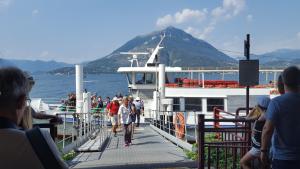 a group of people on a boat in the water at LA PERLA DEL CENTRO LAGO DI COMO in Perledo