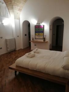 a bedroom with a large white bed in a room at Tito Schipa B&B in Lecce