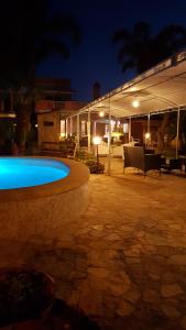 a large swimming pool in a patio at night at B&B Villa Anastasia Club in Mesagne