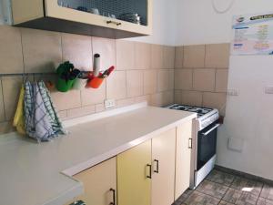 a kitchen with a sink and a stove at Sinai Bagolan in Giv'at Yo'av