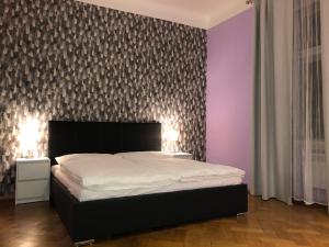a bedroom with a white bed and white walls at Welcome Hostel & Apartments Praguecentre in Prague