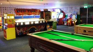 a gaming room with a pool table and a big for sign at Country Coastal Holidays - Families and Couples only in New Romney